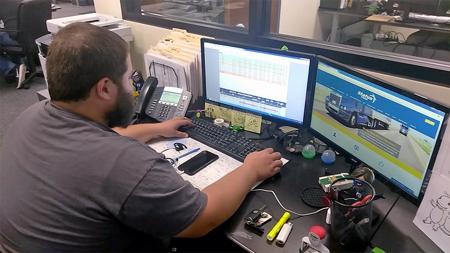 Truck dispatcher working with owner operator on freight loads