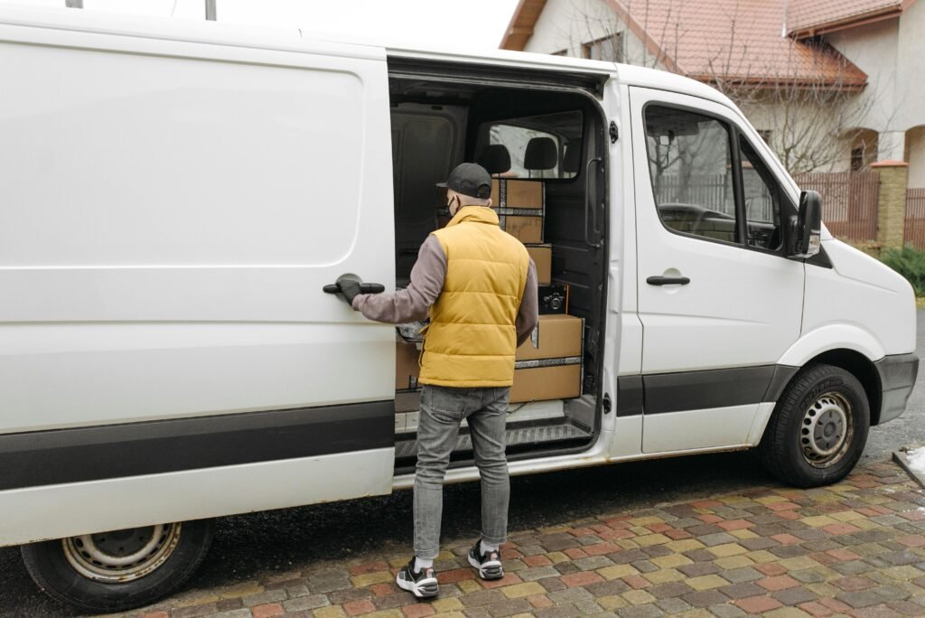 Man Opening a Door of a Delivery Van 