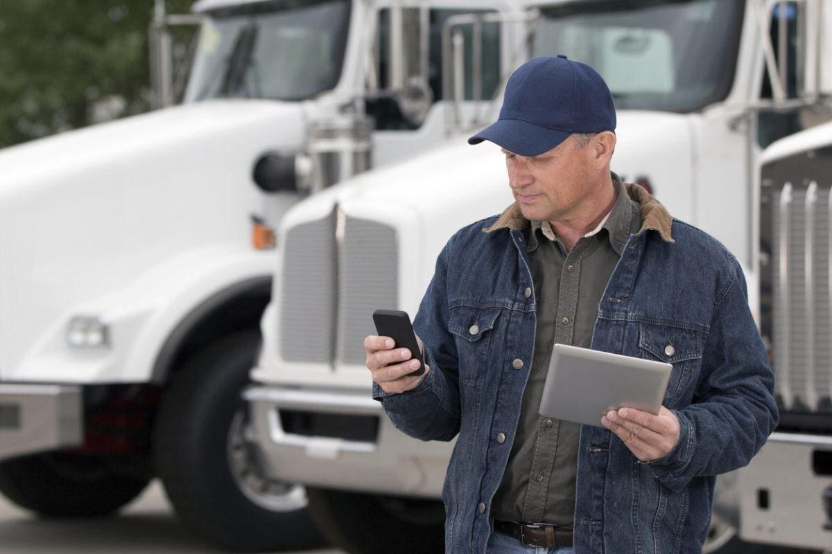 Truck driver calculating trucking operating expenses and profit per mile