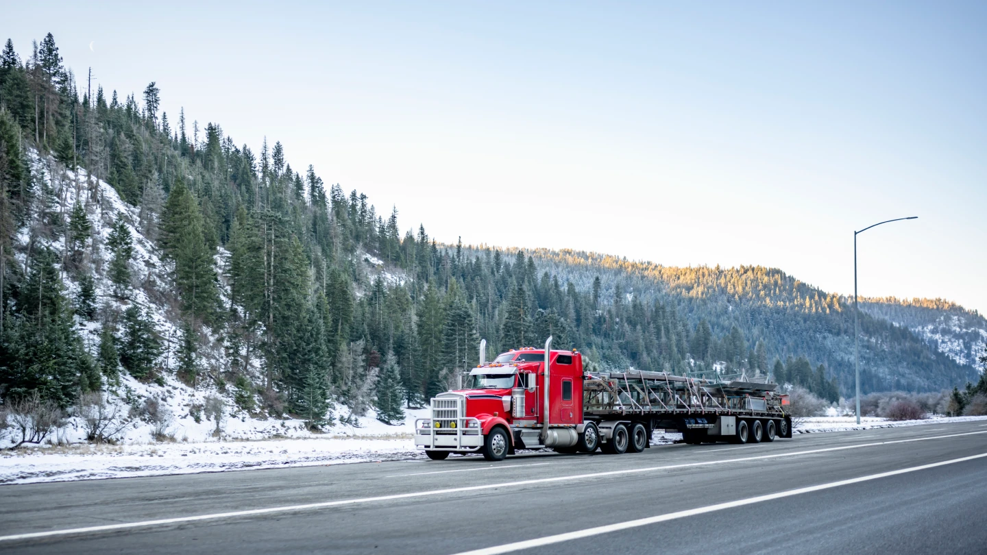 Flatbed truck transporting freight during winter weather