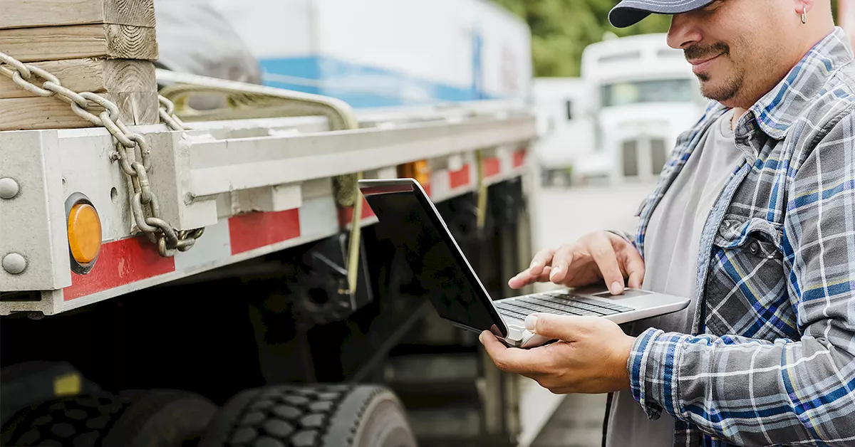 Truck driver reviewing freight options with a dispatch company